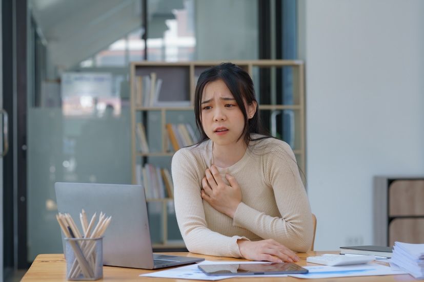 adult at a desk experiencing panic