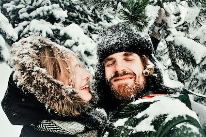 a couple getting cozy in the snow